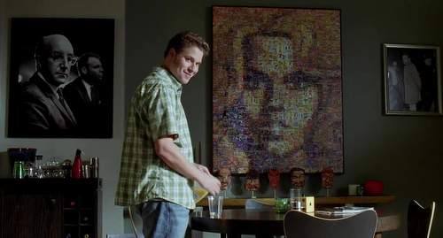 Seth Rogen in front of Barbarella mosaic poster.
Still frame from &lquot;Funny People&rquot; movie.